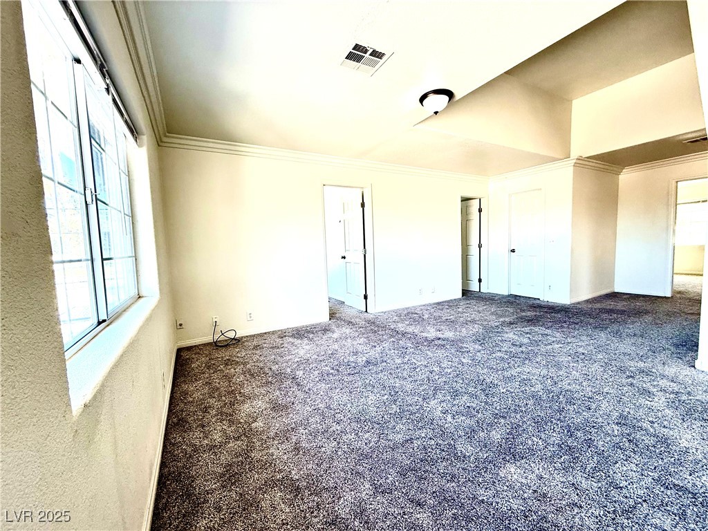 764 Benedict Drive Las Vegas, NV 89110 - Photo 27 of 30 Carpeted spare room with visible vents and crown m