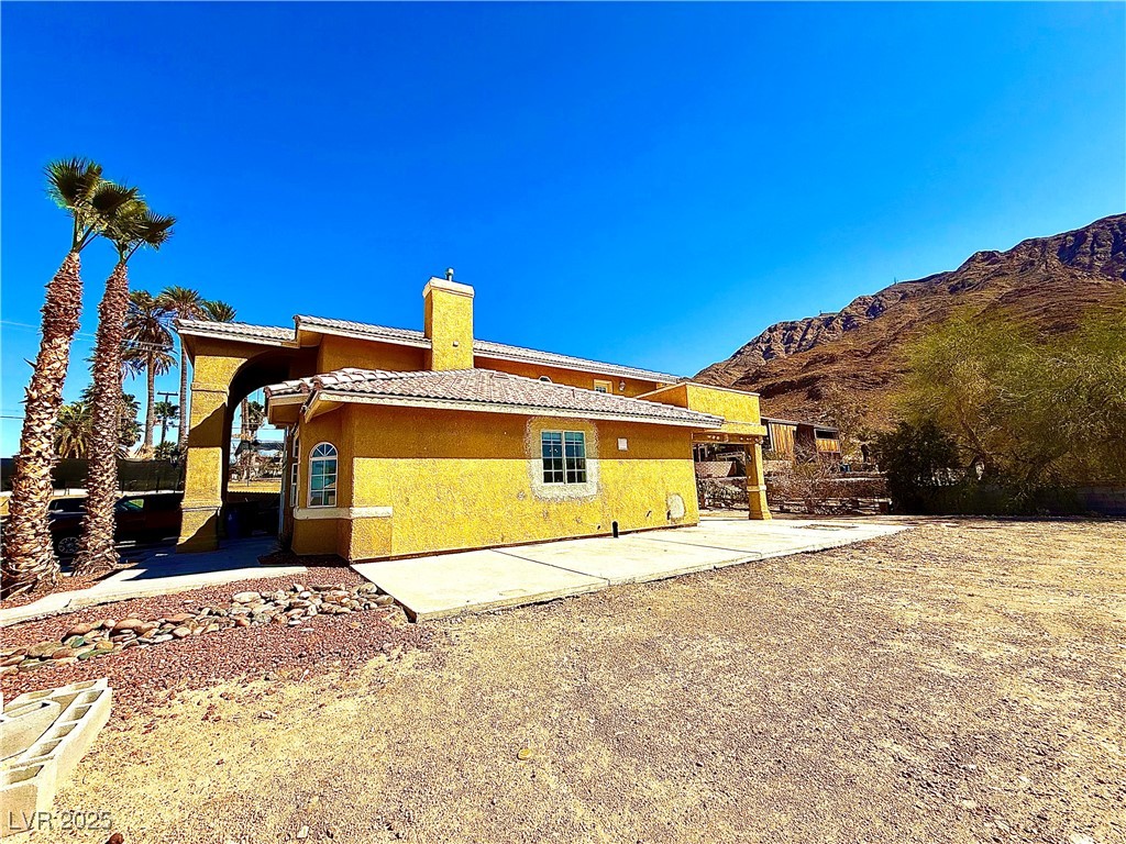 764 Benedict Drive Las Vegas, NV 89110 - Photo 3 of 30 Back of property featuring stucco siding, a mounta