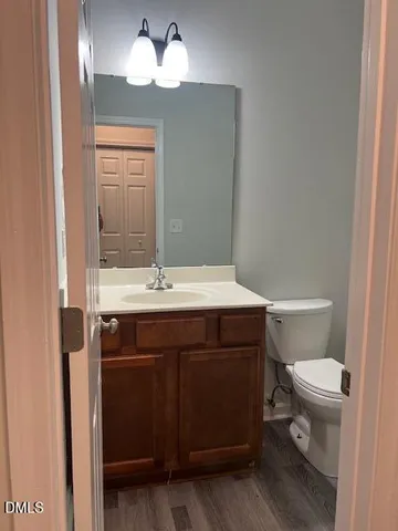 an empty room with wooden floor and a window