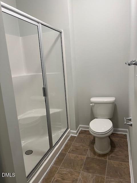 415 Aversboro Road Garner, NC 27529 - Photo 20 of 32 a bathroom with a toilet and a shower