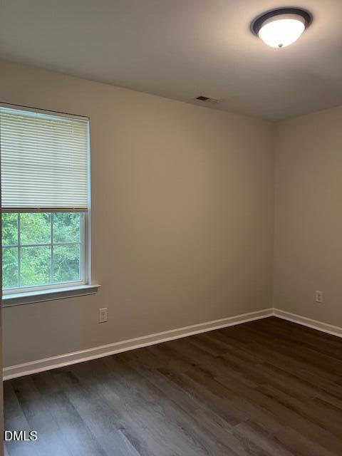 415 Aversboro Road Garner, NC 27529 - Photo 25 of 32 an empty room with wooden floor and windows