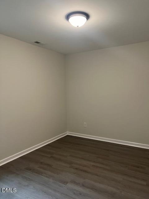 415 Aversboro Road Garner, NC 27529 - Photo 26 of 32 a view of an empty room with wooden floor and a window