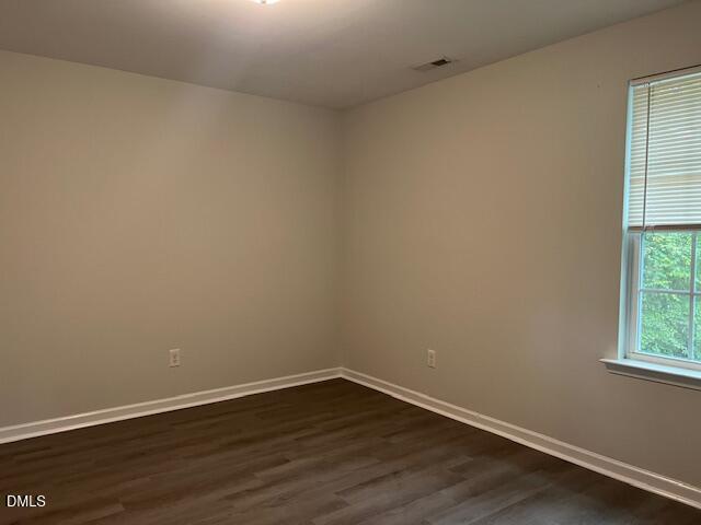 415 Aversboro Road Garner, NC 27529 - Photo 27 of 32 a view of an empty room with wooden floor and a window