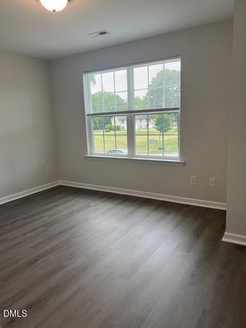 415 Aversboro Road Garner, NC 27529 - Photo 28 of 32 an empty room with wooden floor and windows