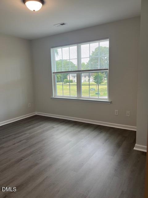 415 Aversboro Road Garner, NC 27529 - Photo 29 of 32 an empty room with wooden floor and windows