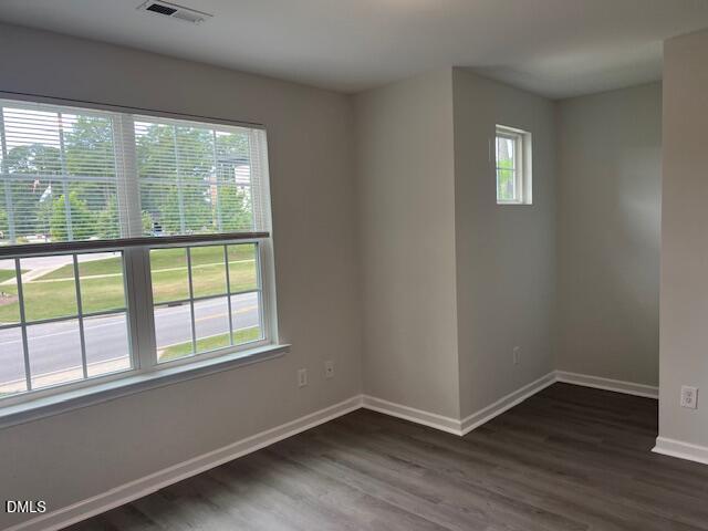 415 Aversboro Road Garner, NC 27529 - Photo 5 of 32 an empty room with wooden floor and windows