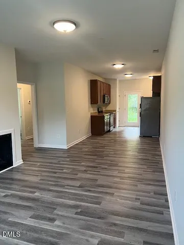 a view of a kitchen center wooden floor and stainless steel appliances