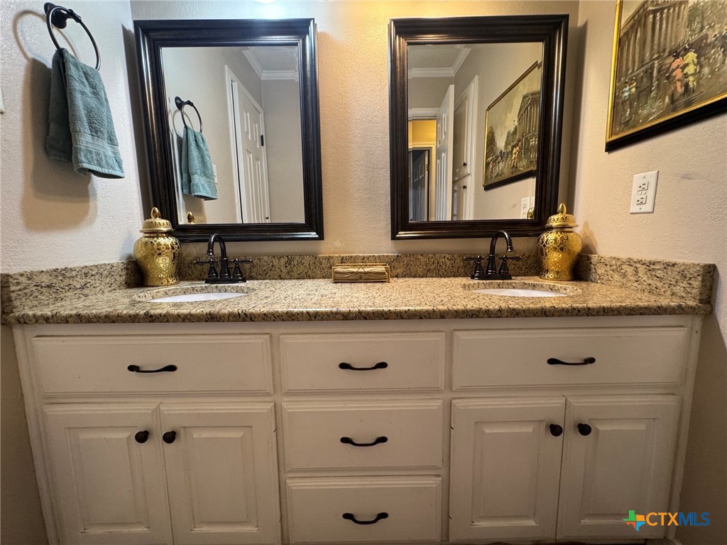 115 Oak Ridge Road Gatesville, TX 76528 - Photo 24 of 37 a bathroom with double vanity sink and two mirror