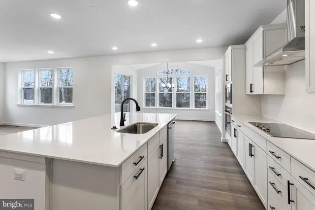 a kitchen with granite countertop a sink and stove