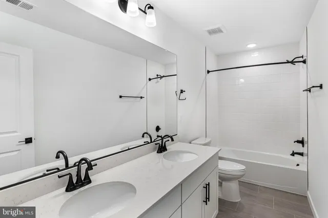 a bathroom with a sink vanity granite toilet tub and shower