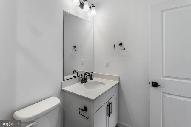 a bathroom with a sink toilet and mirror