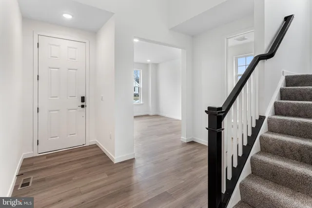 a view of an entryway with wooden floor