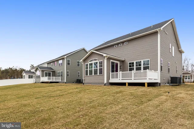 a view of a house with a big yard and large trees