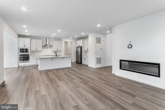 a view of kitchen with wooden floor and electronic appliances