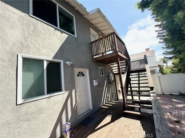 a balcony with table and chairs