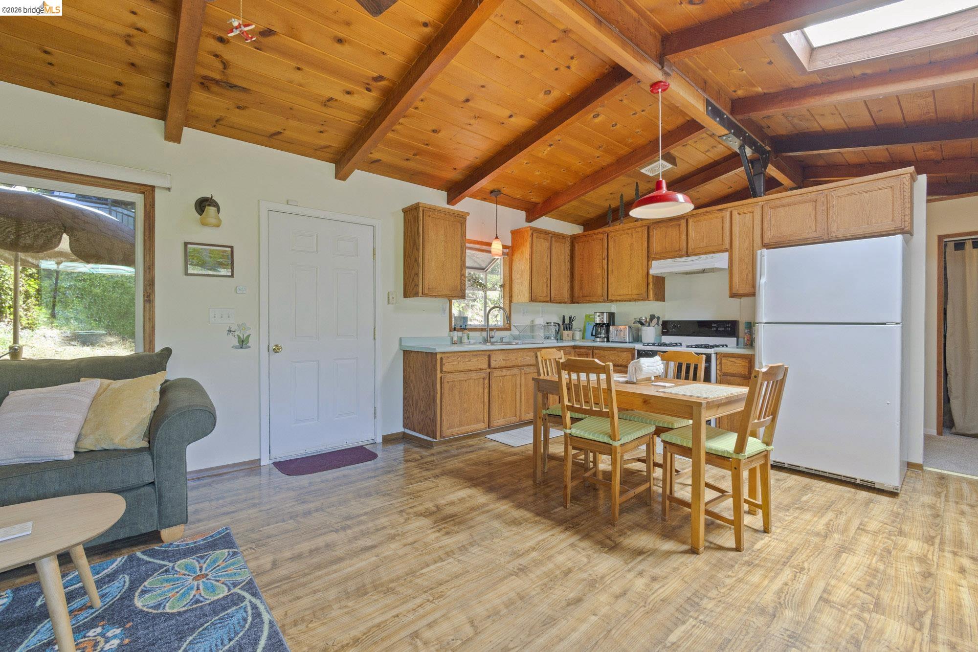 21815 Confidence Road Twain Harte, CA 95383 - Photo 5 of 30 a dining room with wooden floors a couch and appliances