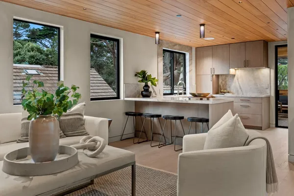 a kitchen with a table chairs refrigerator and cabinets