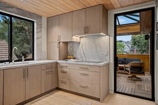 a kitchen with sink cabinets and outdoor living space