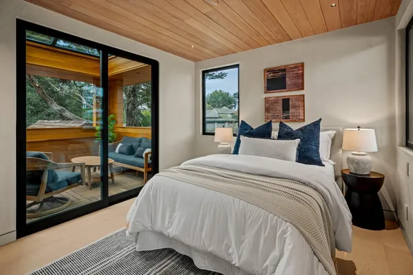 a bedroom with bed and a large window