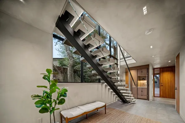 a living room with furniture and a potted plant