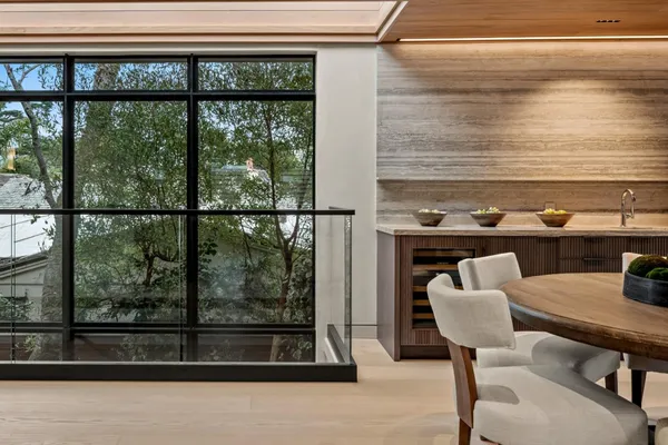 a dining room with furniture and a large window