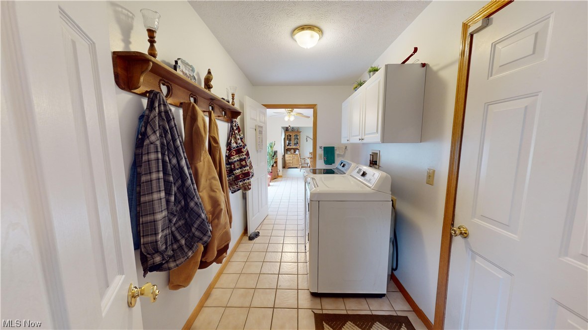 12431 Carter Road Painesville, OH 44077 - Photo 10 of 33 Laundry area with a textured ceiling, cabinets, light tile flooring, washing machine and dryer, and ceiling fan
