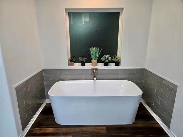 a white bath tub sitting in a bathroom
