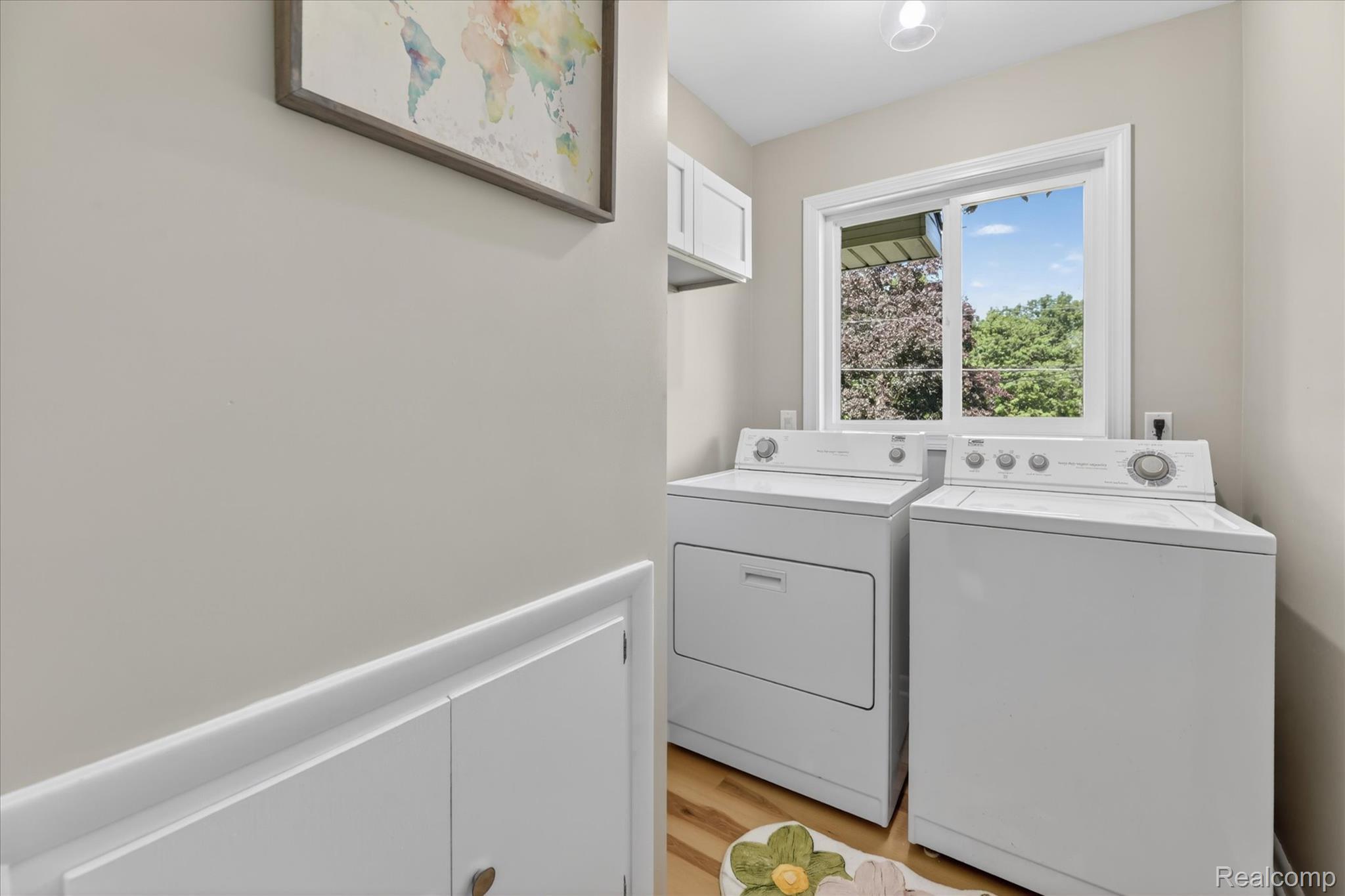 2250 Montague Road Davison, MI 48423 - Photo 28 of 45 Dedicated laundry area featuring a large window, light wood-finish flooring, and crisp white cabinetry