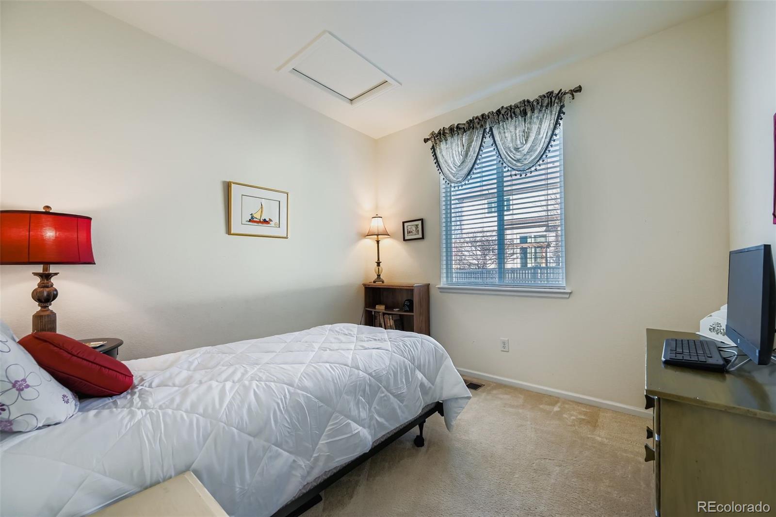 4712 Sandy Ridge Avenue Firestone, CO 80504 - Photo 18 of 29 a bedroom with a bed and a flat screen tv