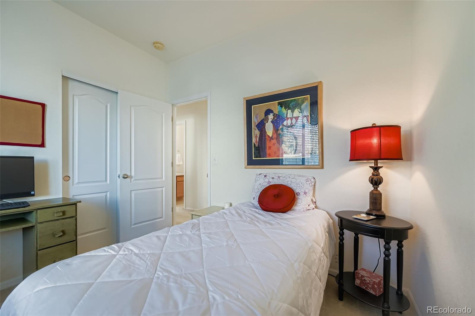 4712 Sandy Ridge Avenue Firestone, CO 80504 - Photo 19 of 29 a bedroom with a bed and a flat screen tv