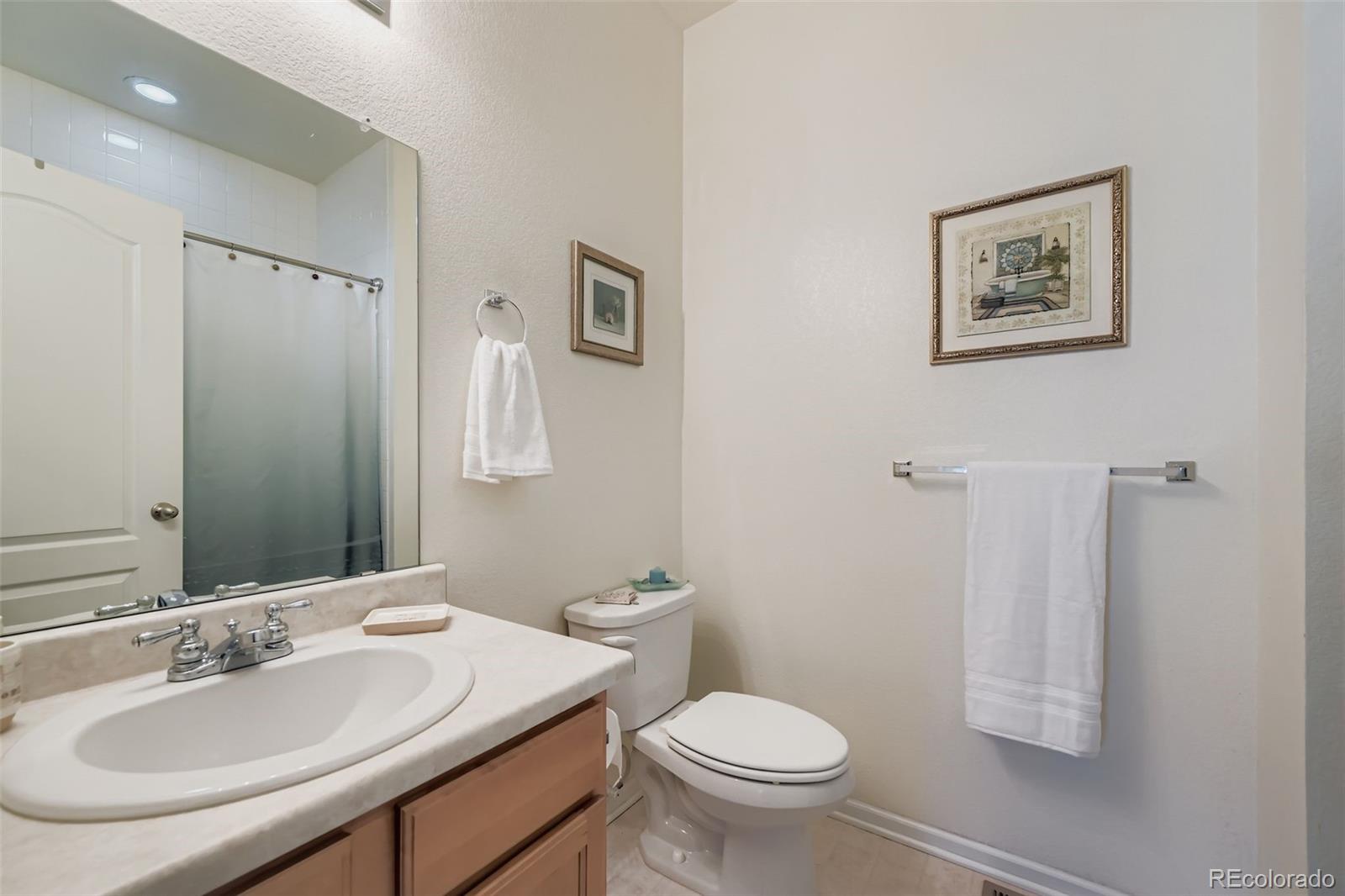 4712 Sandy Ridge Avenue Firestone, CO 80504 - Photo 20 of 29 a bathroom with a toilet sink and mirror