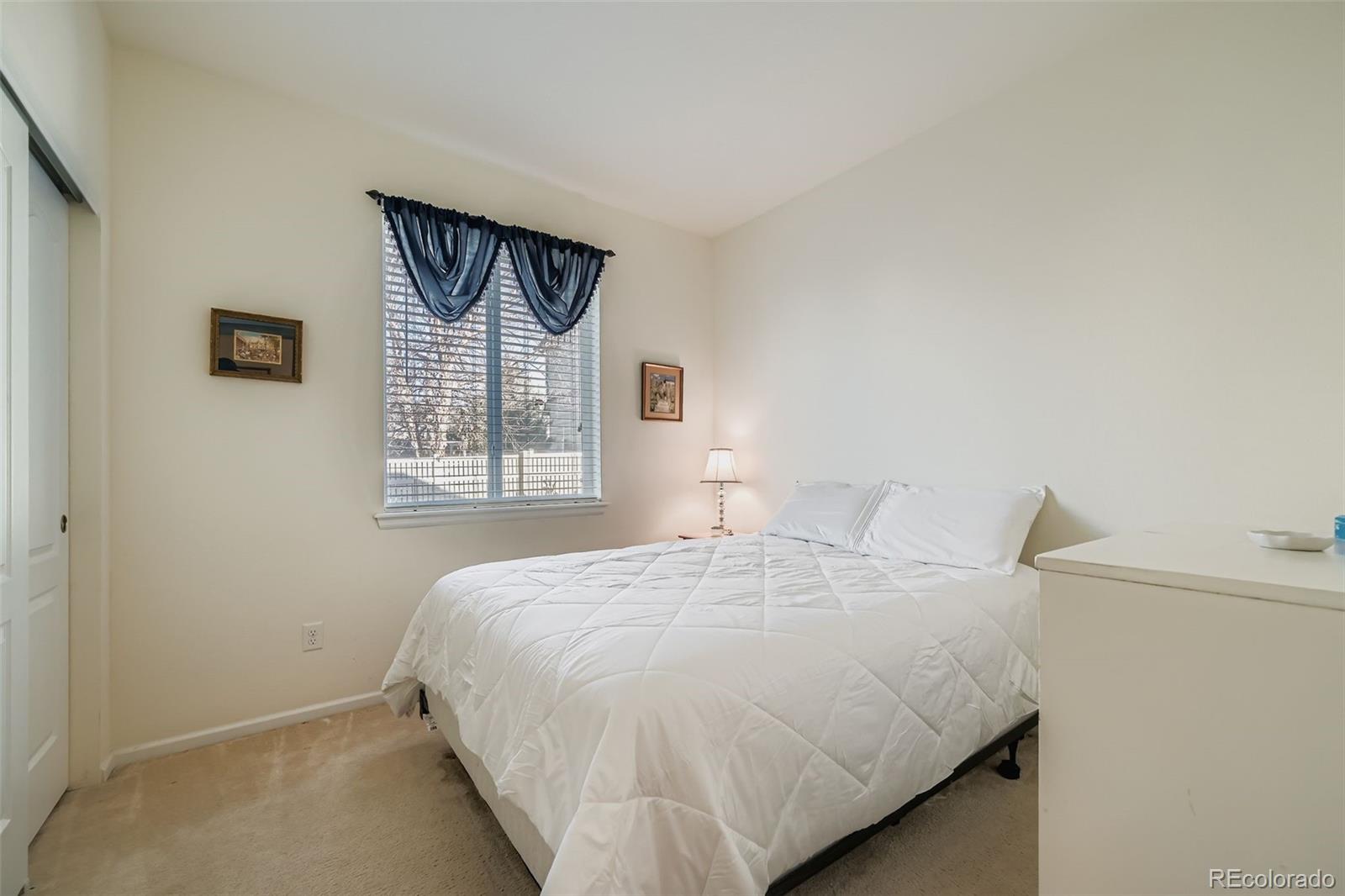 4712 Sandy Ridge Avenue Firestone, CO 80504 - Photo 21 of 29 a bedroom with a bed and a window