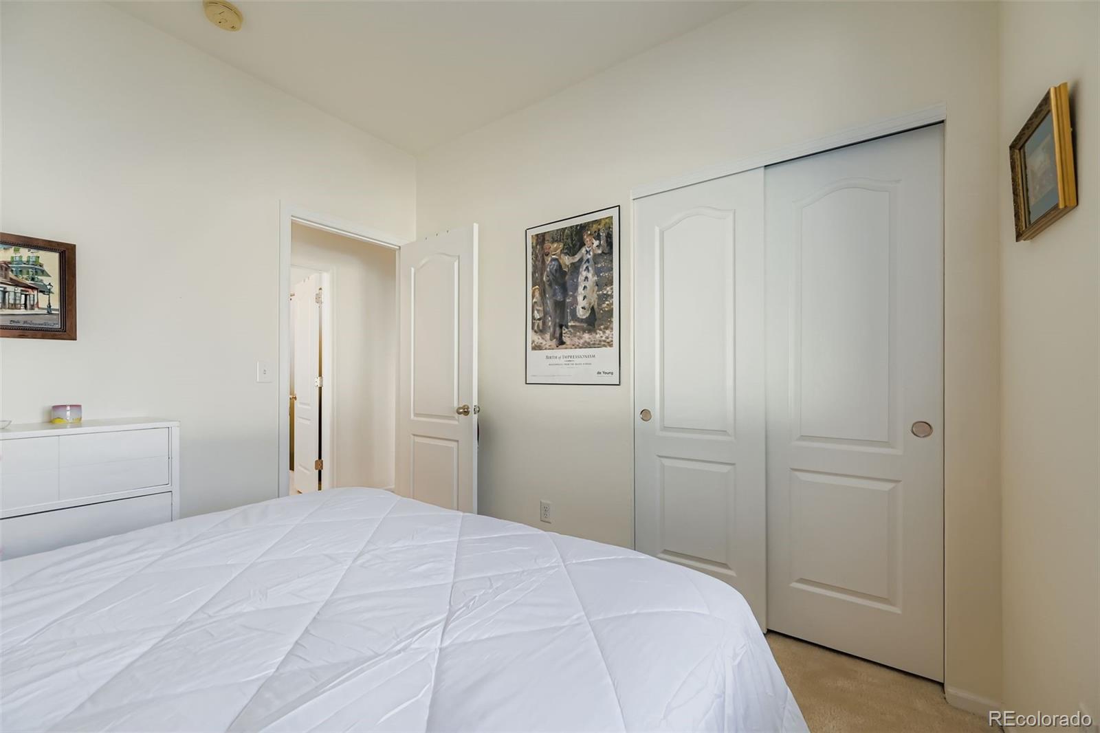 4712 Sandy Ridge Avenue Firestone, CO 80504 - Photo 22 of 29 a bedroom with a bed and cabinets