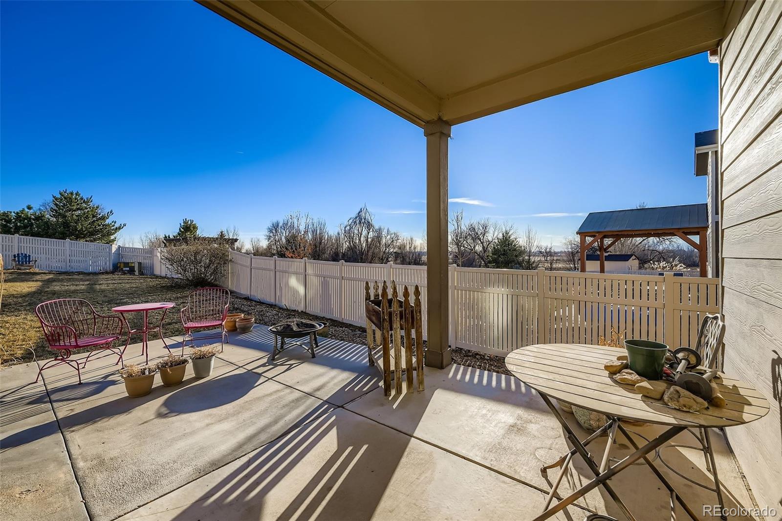 4712 Sandy Ridge Avenue Firestone, CO 80504 - Photo 23 of 29 a view of a balcony with chairs and a table