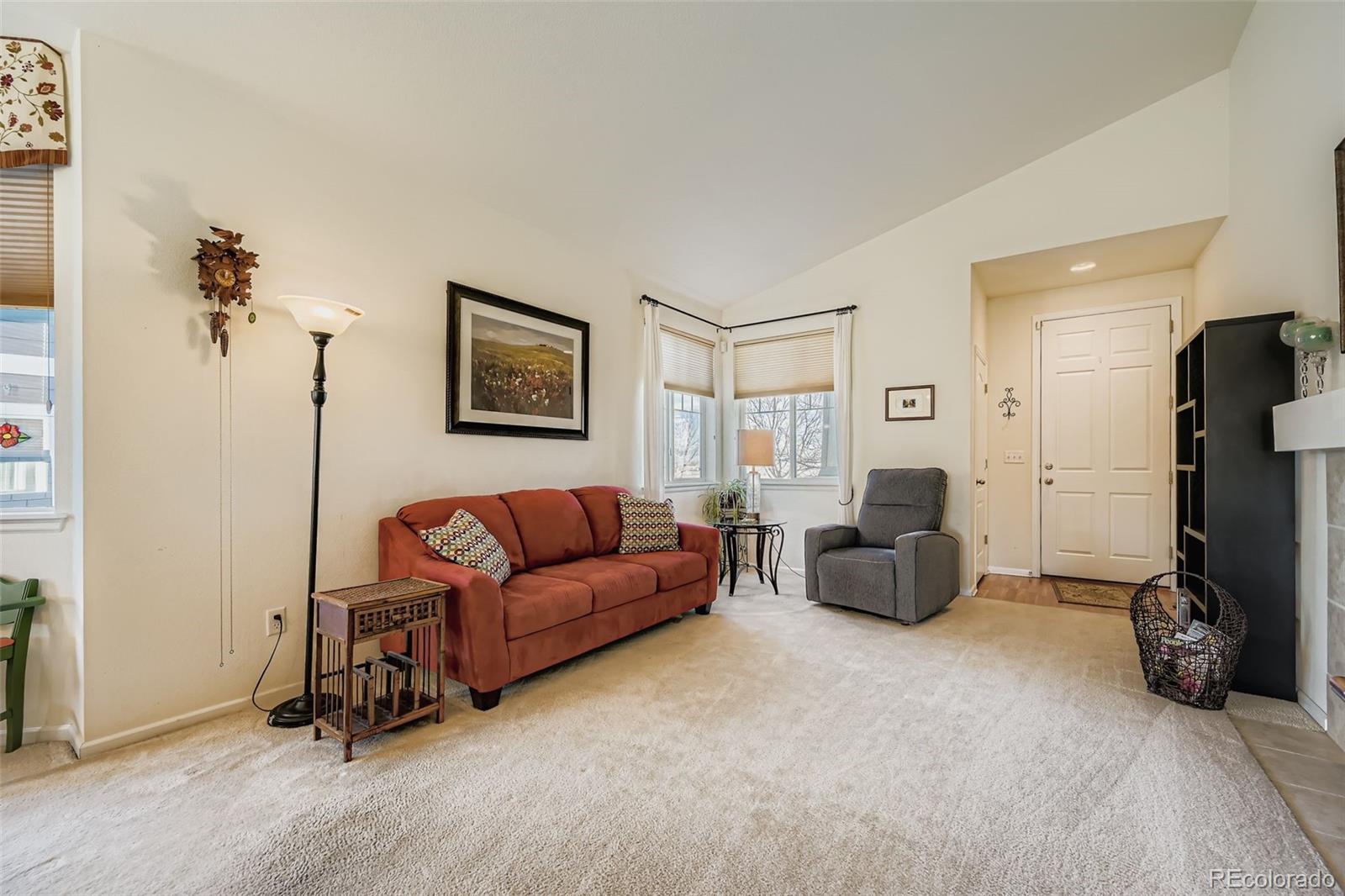 4712 Sandy Ridge Avenue Firestone, CO 80504 - Photo 5 of 29 a living room with furniture gym equipment and a flat screen tv