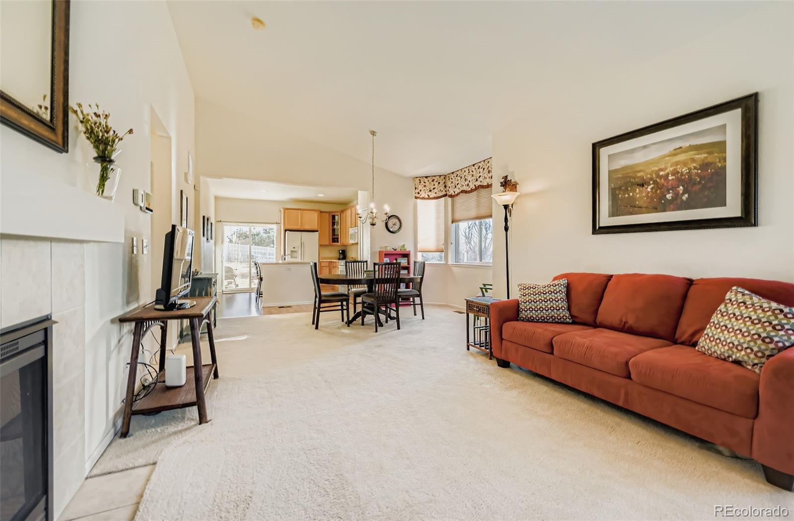 4712 Sandy Ridge Avenue Firestone, CO 80504 - Photo 7 of 29 a living room with furniture a dining table with rug and white walls