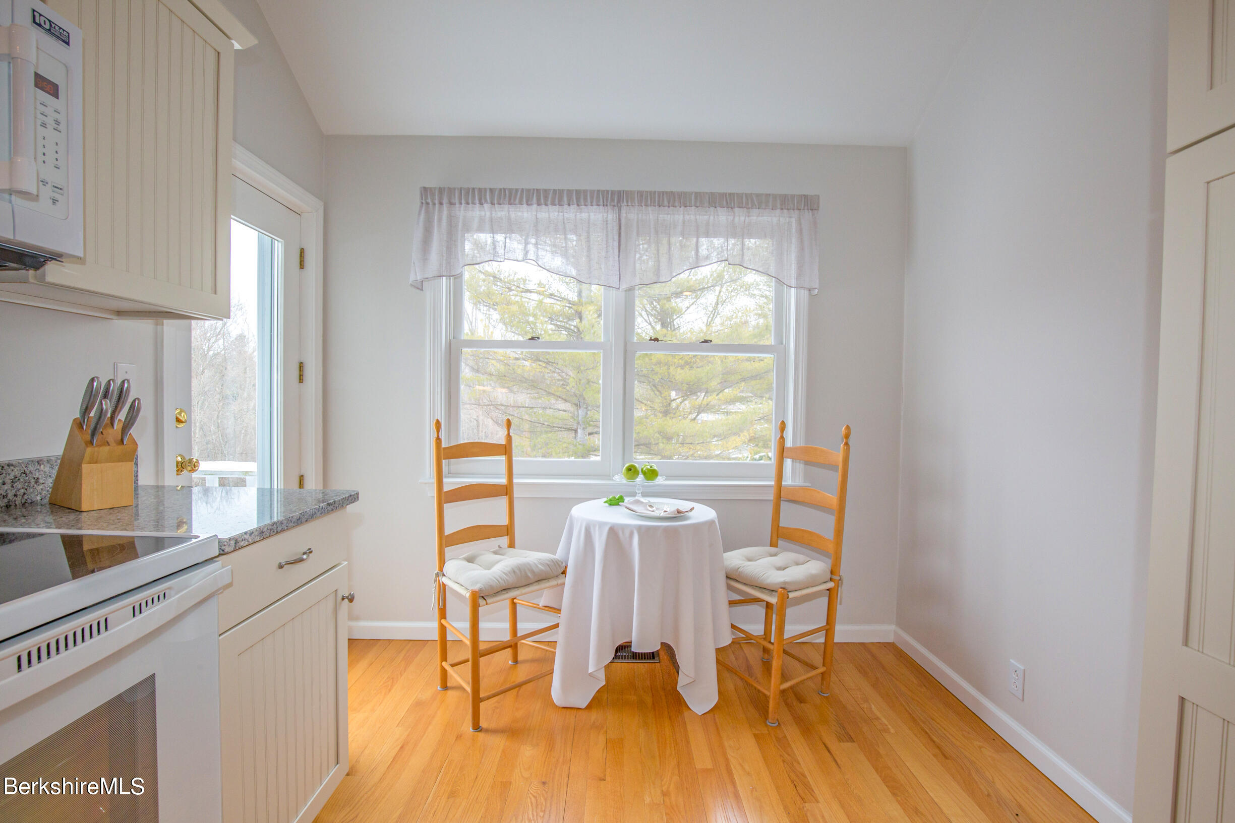 1136 Barker Road, Unit 9 Pittsfield, MA 01201 - Photo 15 of 60 a dining room with wooden floor and a table
