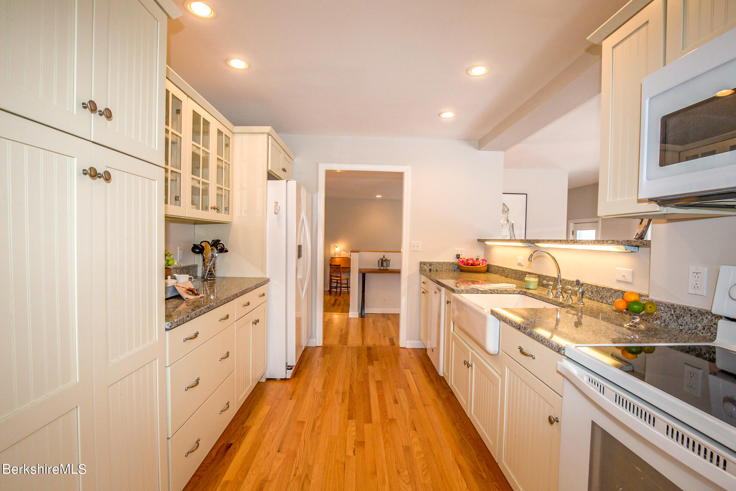 1136 Barker Road, Unit 9 Pittsfield, MA 01201 - Photo 16 of 60 a large kitchen with stainless steel appliances granite countertop a lot of counter space and wooden floors
