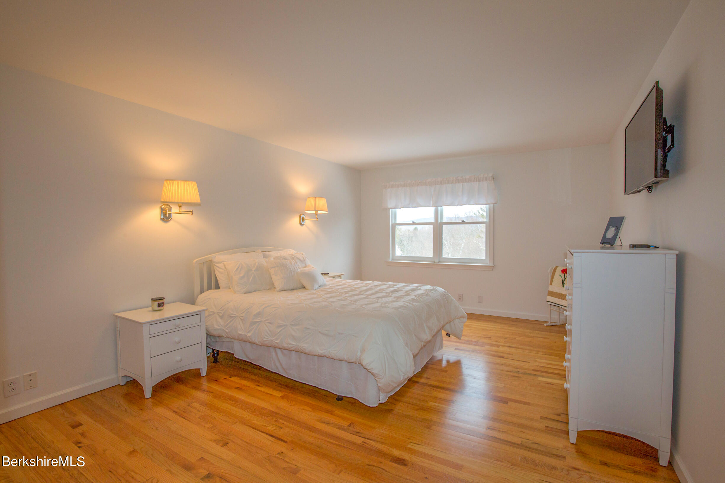 1136 Barker Road, Unit 9 Pittsfield, MA 01201 - Photo 25 of 60 a bedroom with a bed and a flat screen tv