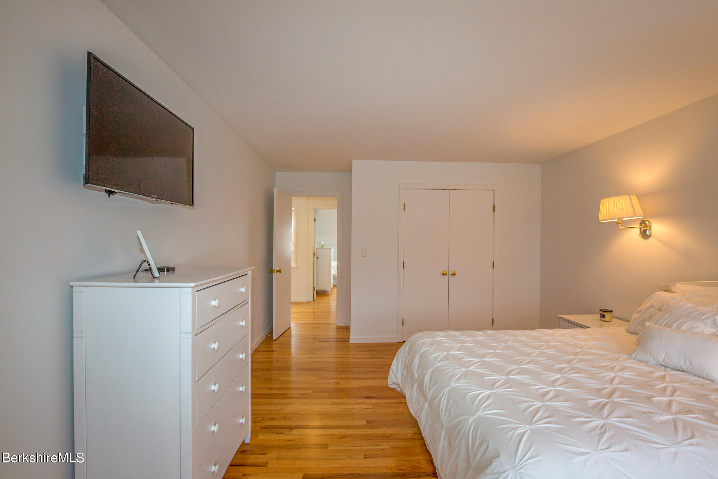 1136 Barker Road, Unit 9 Pittsfield, MA 01201 - Photo 26 of 60 a bedroom with a bed and a flat screen tv