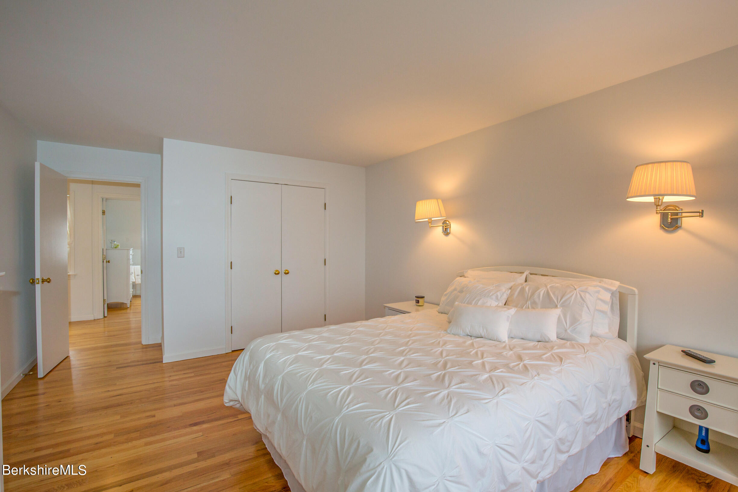 1136 Barker Road, Unit 9 Pittsfield, MA 01201 - Photo 27 of 60 a bedroom with a bed and wooden floor