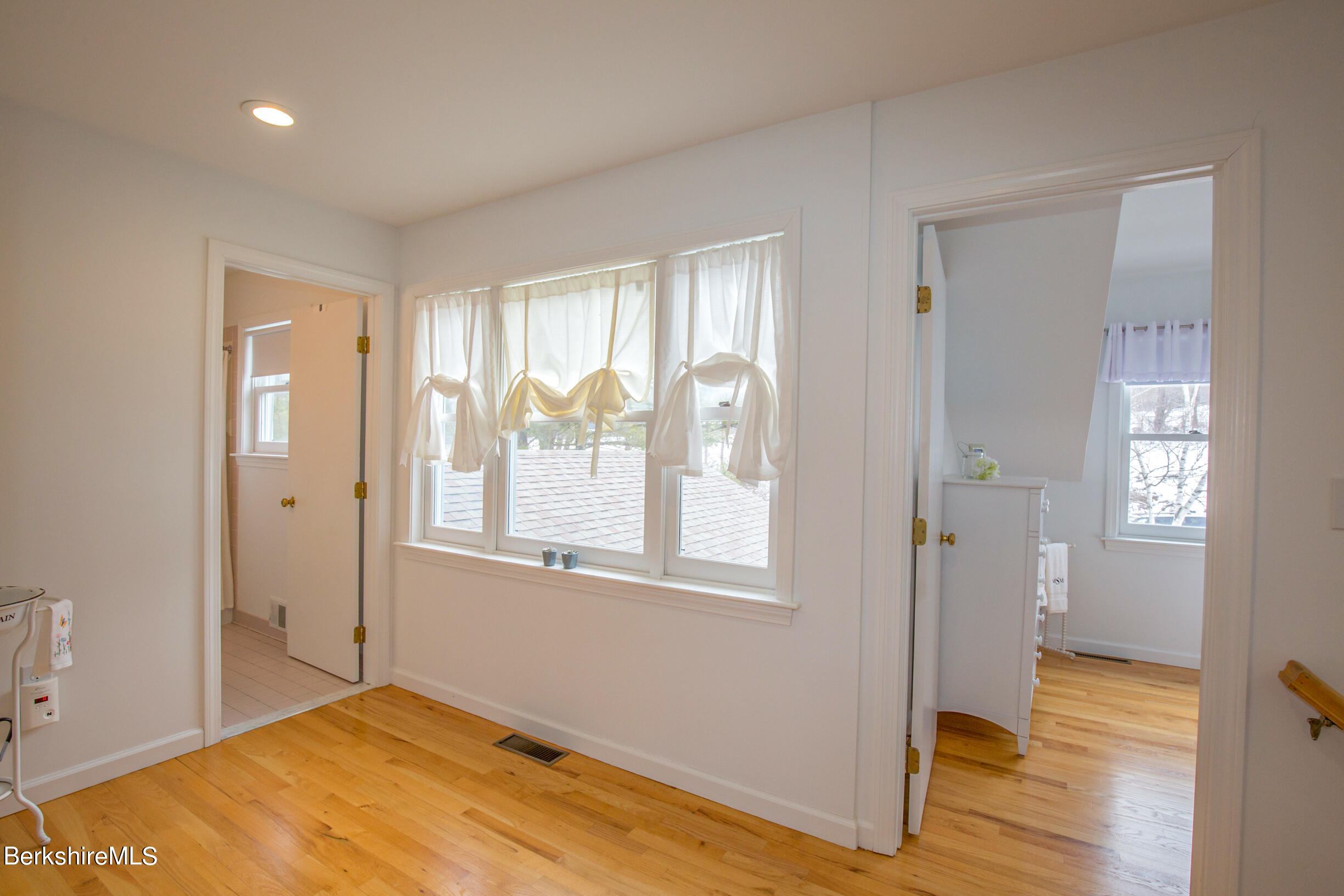 1136 Barker Road, Unit 9 Pittsfield, MA 01201 - Photo 28 of 60 a view of empty room with wooden floor and fan