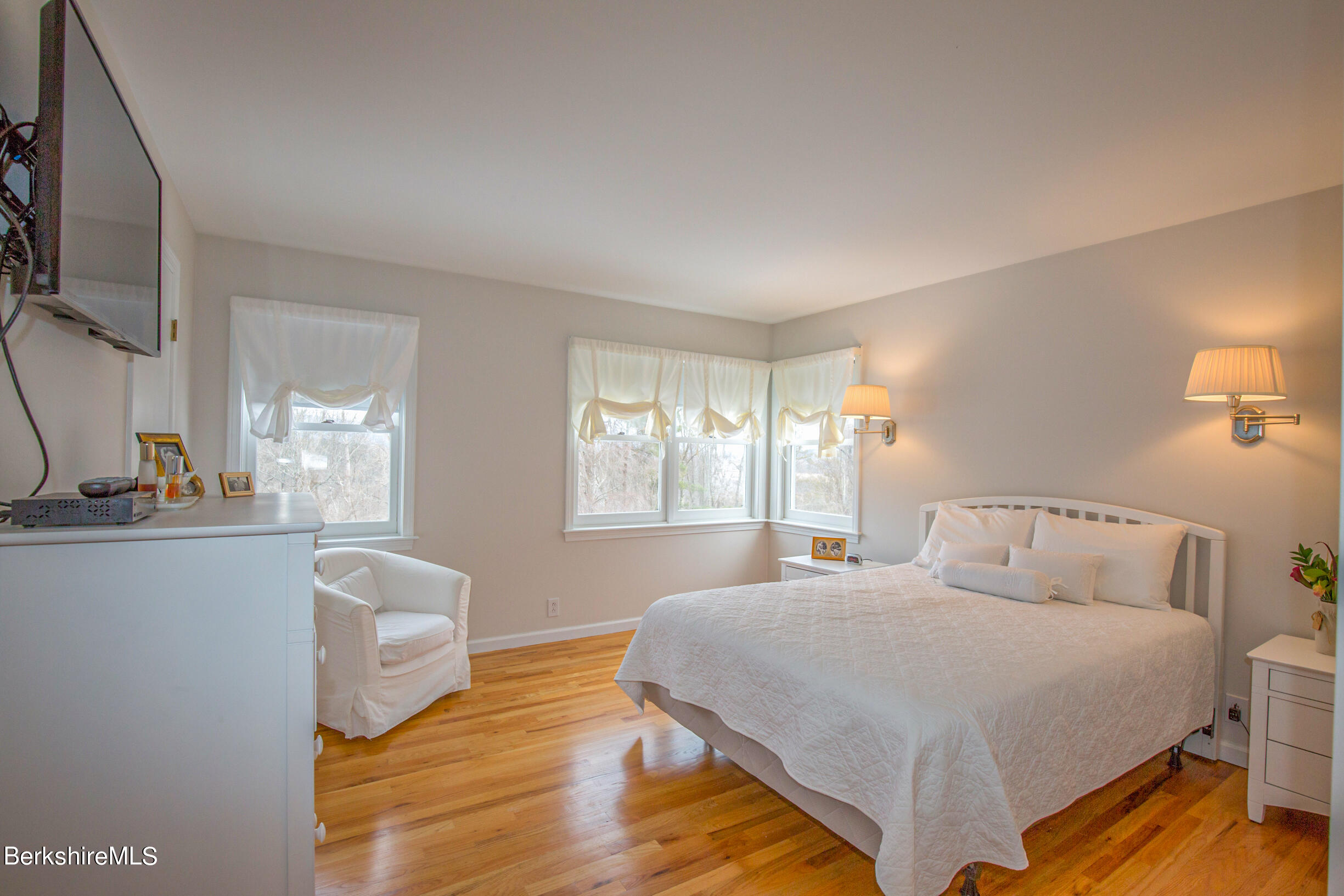 1136 Barker Road, Unit 9 Pittsfield, MA 01201 - Photo 29 of 60 a bedroom with a bed and wooden floor