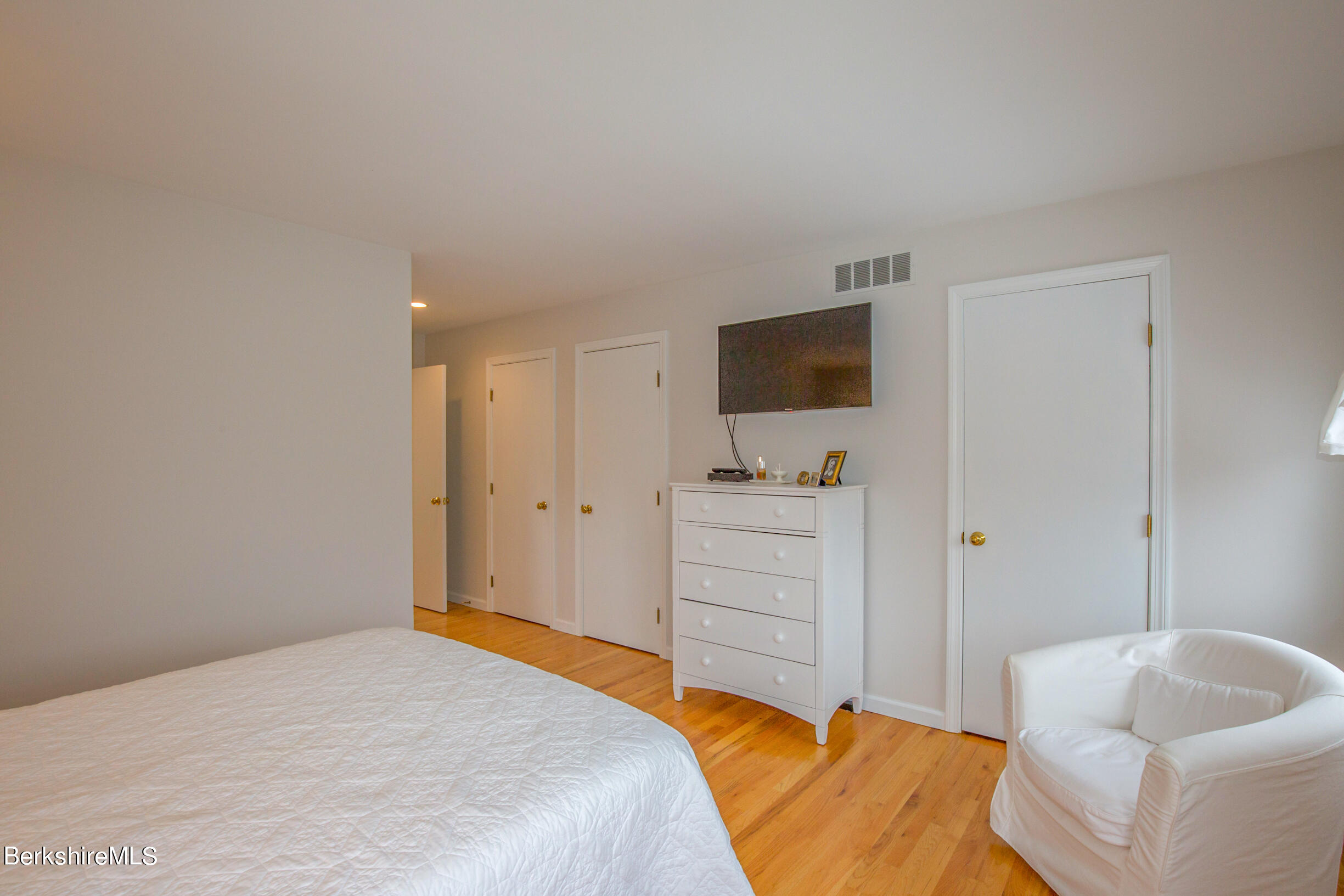 1136 Barker Road, Unit 9 Pittsfield, MA 01201 - Photo 30 of 60 a bedroom with a bed and a flat screen tv
