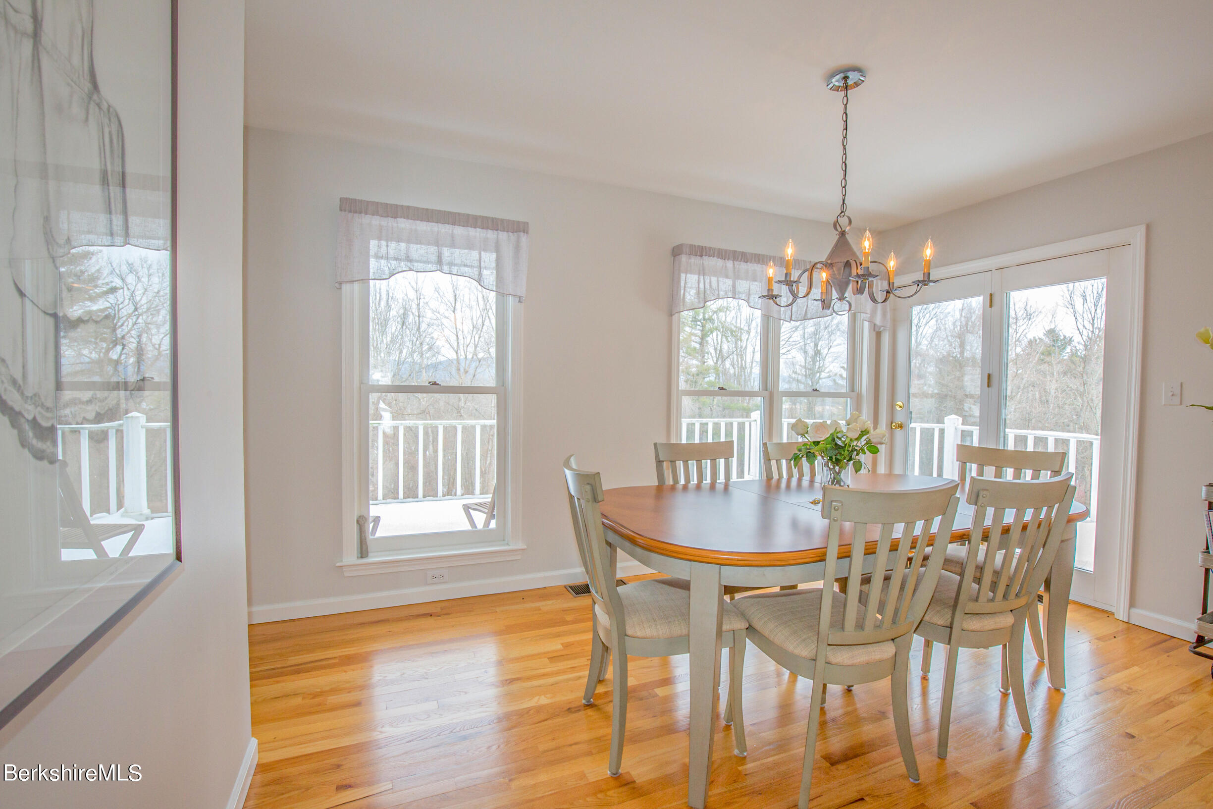 1136 Barker Road, Unit 9 Pittsfield, MA 01201 - Photo 3 of 60 a view of a dining room with furniture wooden floor and chandelier