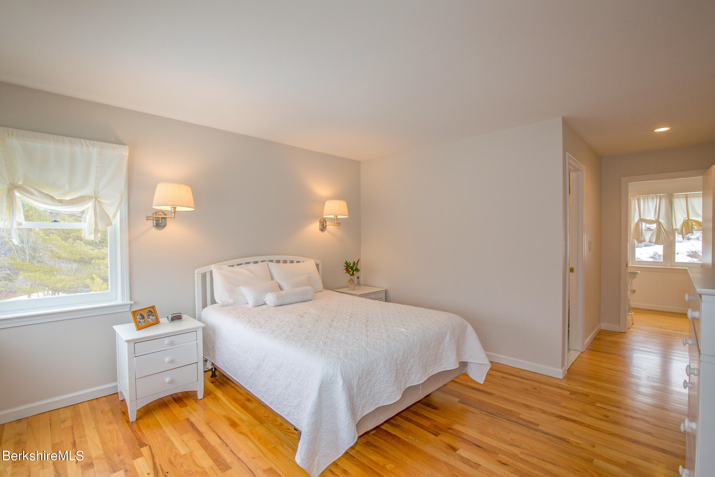 1136 Barker Road, Unit 9 Pittsfield, MA 01201 - Photo 31 of 60 a bedroom with a bed and wooden floor