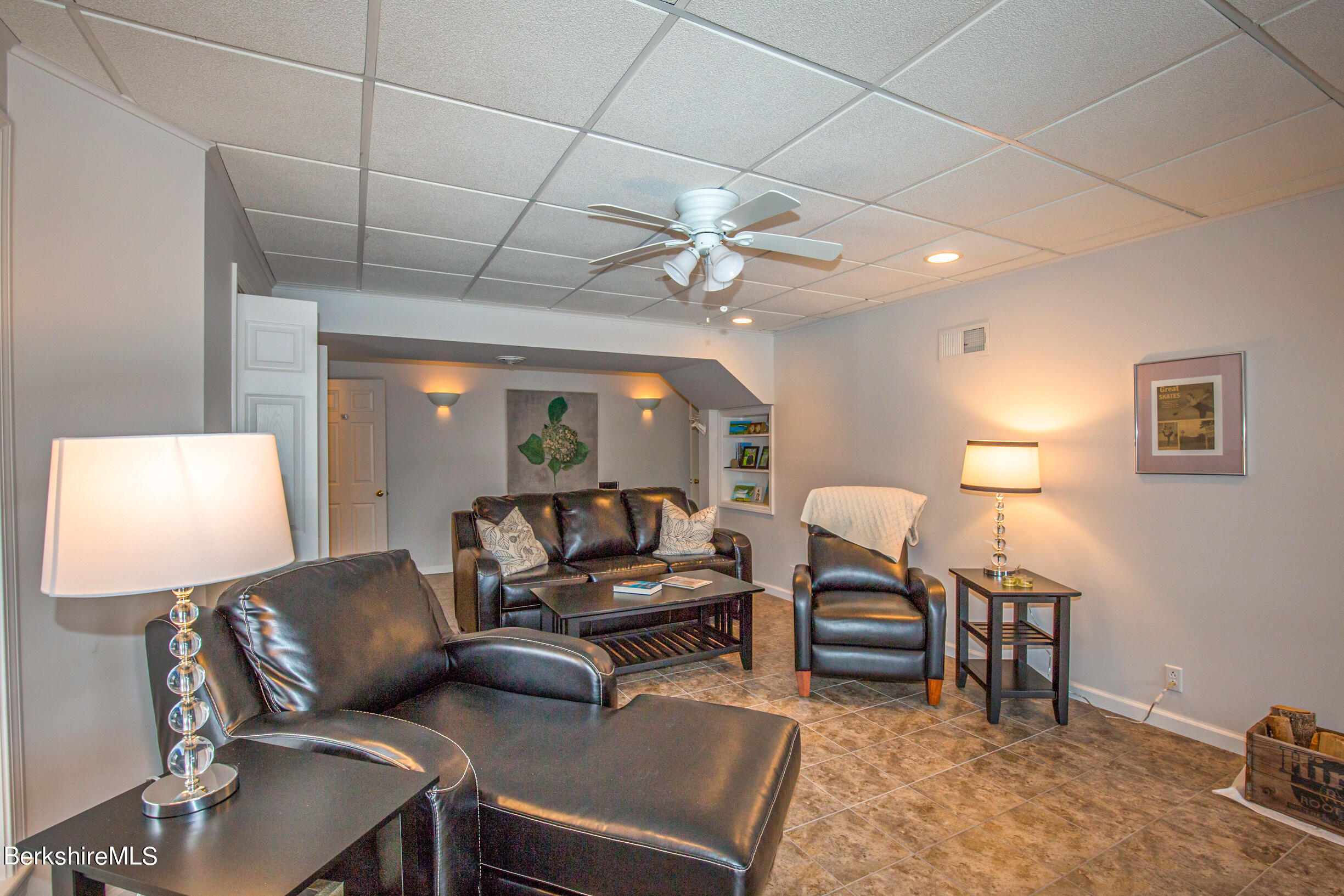 1136 Barker Road, Unit 9 Pittsfield, MA 01201 - Photo 35 of 60 a living room with furniture a lamp and a flat screen tv