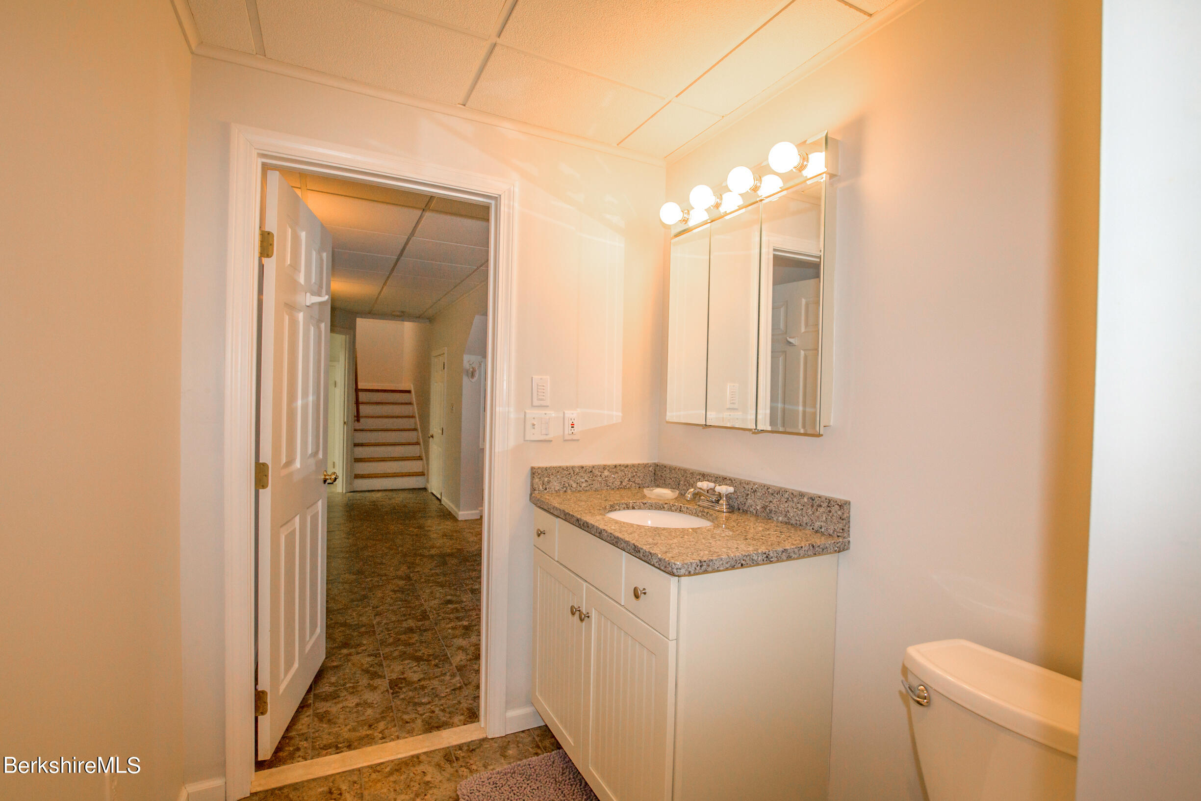 1136 Barker Road, Unit 9 Pittsfield, MA 01201 - Photo 37 of 60 a bathroom with a granite countertop sink and a mirror
