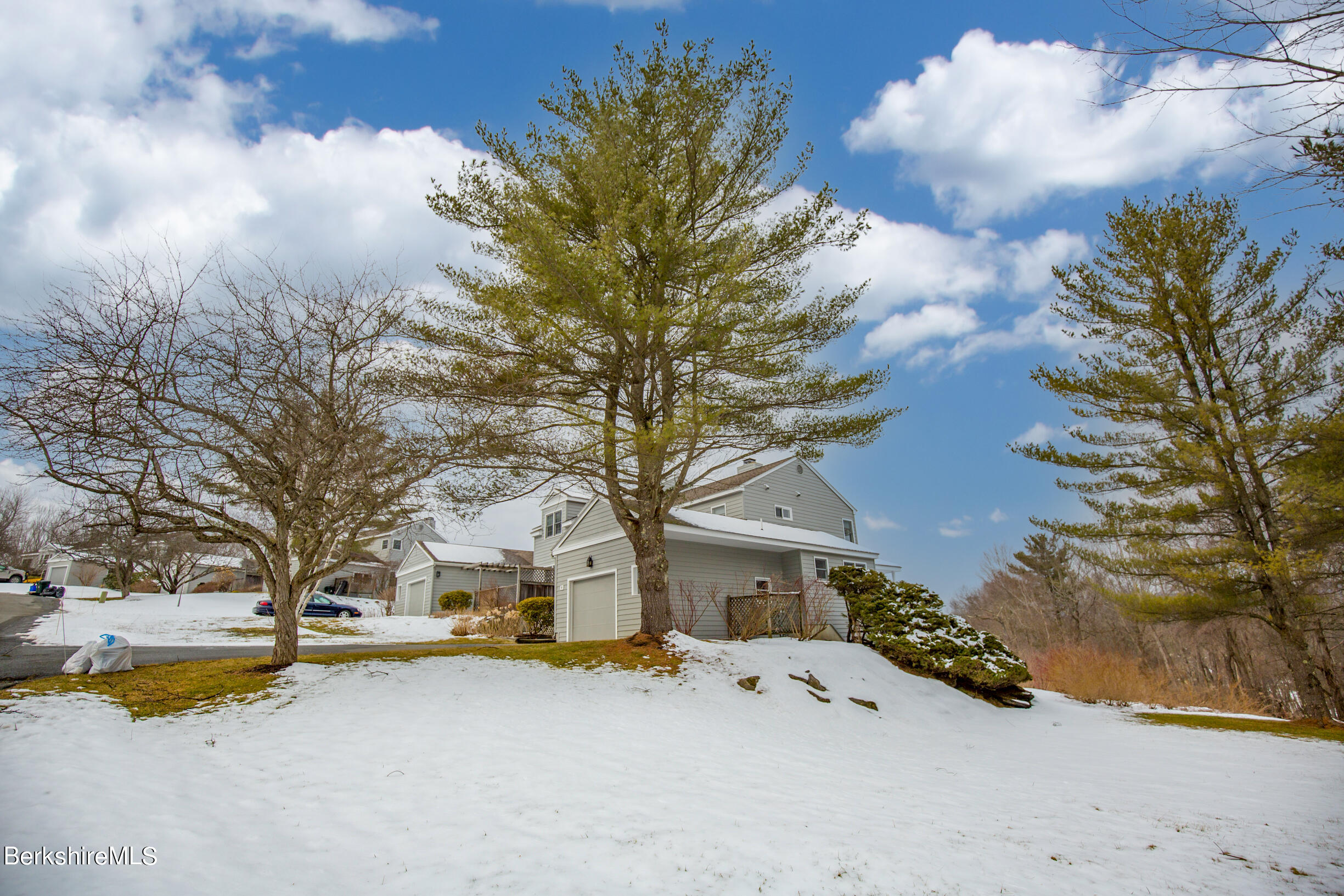 1136 Barker Road, Unit 9 Pittsfield, MA 01201 - Photo 45 of 60 a view of a house with a snow in the yard