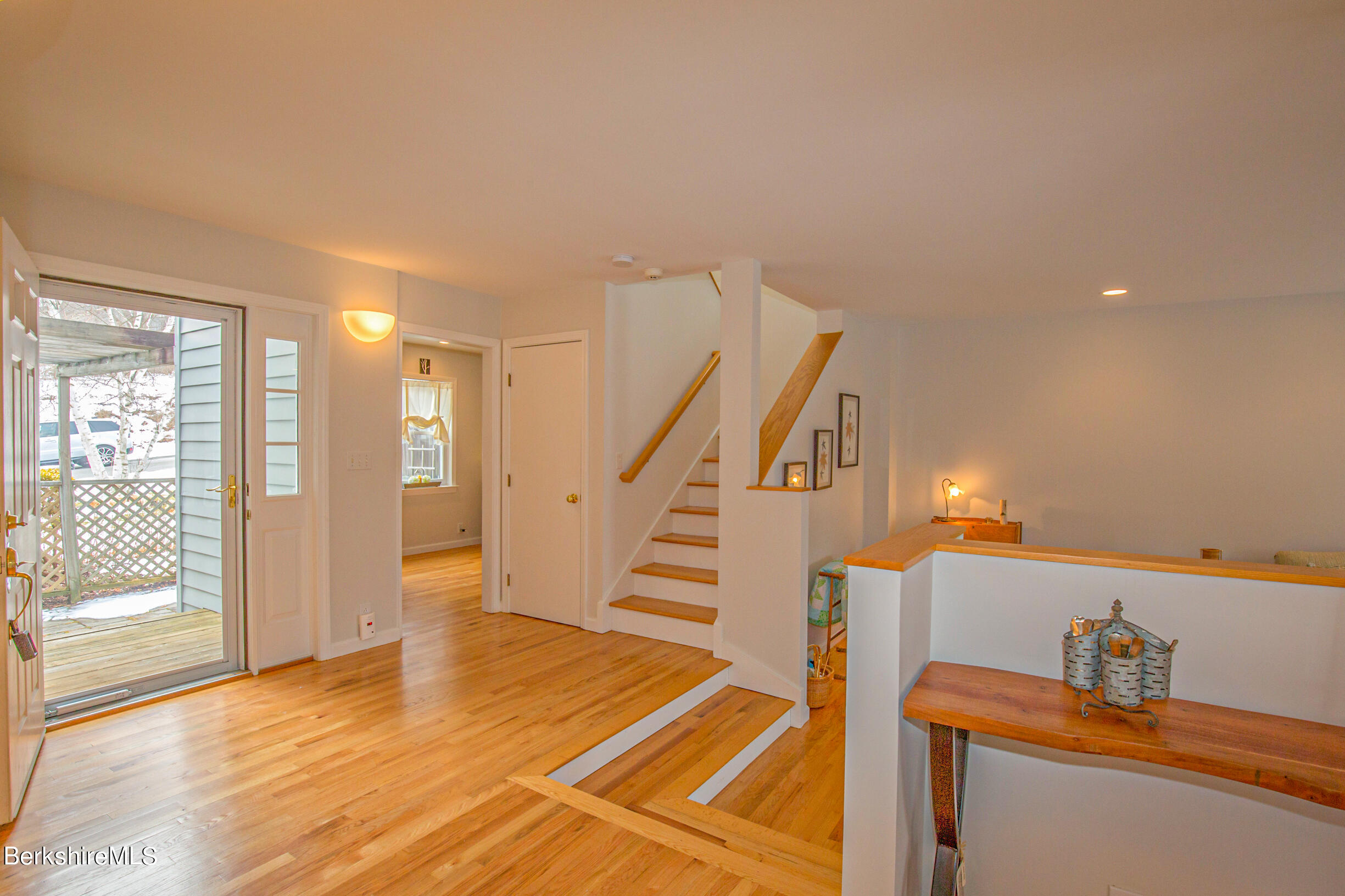 1136 Barker Road, Unit 9 Pittsfield, MA 01201 - Photo 10 of 60 a view of a livingroom with wooden floor and stairs